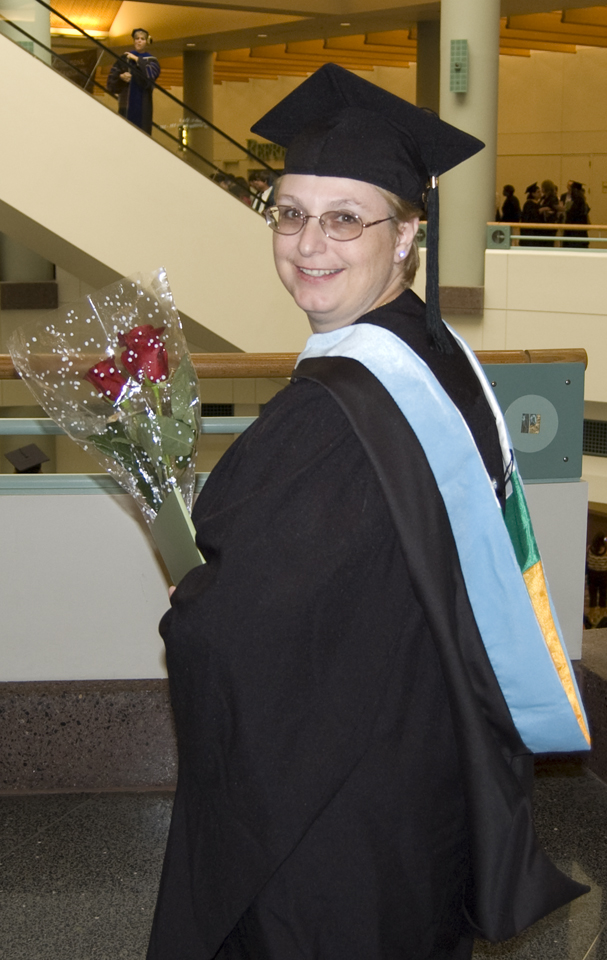 The proud grad showing off her hood